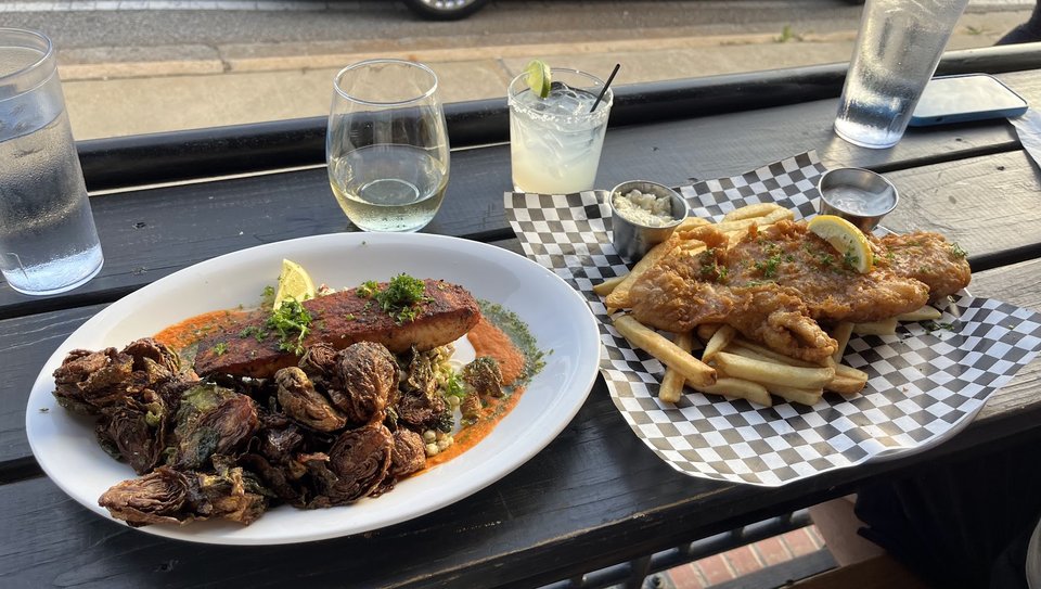 Drinks, plates, and relaxed seating inside a Rock Hill bar.