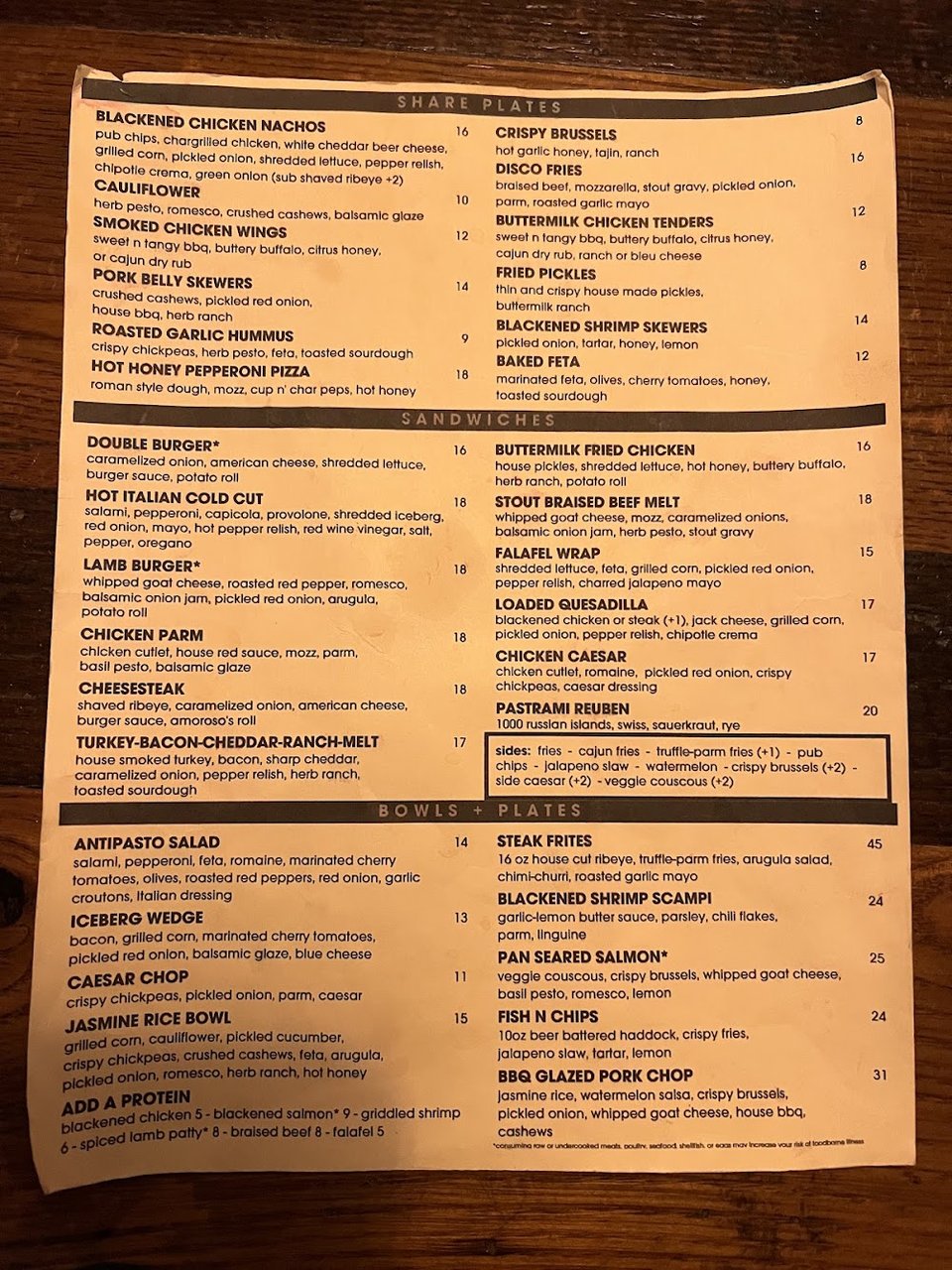 Cocktails, beer, and food items on a menu.